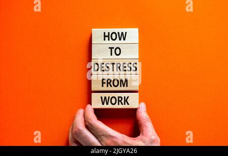 Destress from work symbol. Concept words How to destress from work on wooden blocks. Doctor hand. Beautiful orange background. Psychological business Stock Photo
