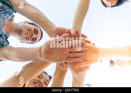 Teamwork, unity concept, group of friends put their hands together. Stock Photo