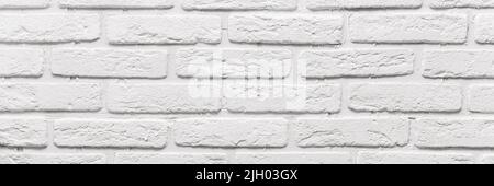 long white brick wall. The texture of the old brick painted with white paint. Web banner. Stock Photo