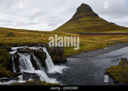 Kirkjufell is by now an iconic mountain in Iceland. 'A mountain shaped like an arrowhead', was the description it was given in Game of Thrones. Stock Photo