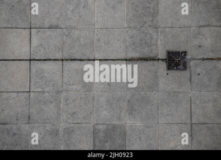 Granite mosaic floor. Construction materials storm drain grate Stock Photo