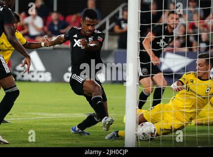 WASHINGTON, DC, USA - 13 JULY 2022: D.C. United forward Ola Kamara (9) kicks past Columbus Crew forward Pedro Santos (7) to score in extra time to tie the game during a MLS match between D.C United and the Columbus Crew  on July 13 2022, at Audi Field, in Washington, DC. (Photo by Tony Quinn-Alamy Live News) Stock Photo