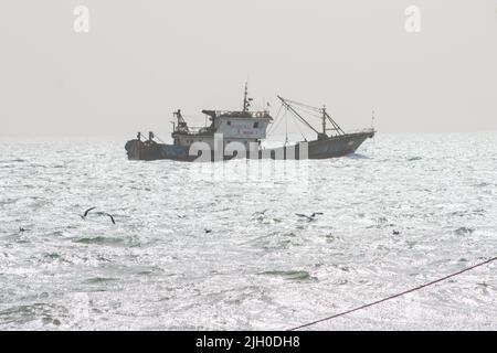 PORTUGUESE TOWN, BANJUL, THE GAMBIA - FEBRUARY 10, 2022 local trawler coming in Stock Photo