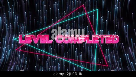 Image of level completed text over light trails on black background Stock Photo