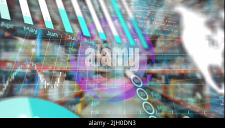 Image of graph, charts, globe and data processing over warehouse interior Stock Photo