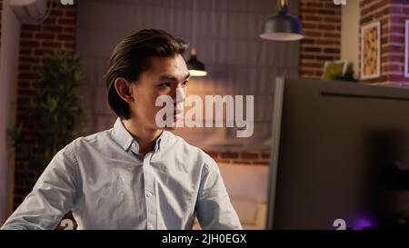 Office worker taking notes on document to plan economic report, using computer and paperwork data. Writing email with business presentation, browsing internet website. . Stock Photo