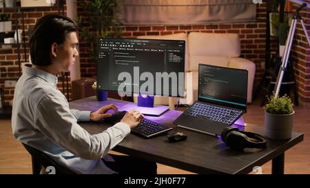 Asian programmer using binary code to script security system ...