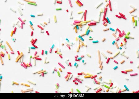 Candy multi colored sprinkles background. Rainbow coloured sprinkles on white background. Stock Photo