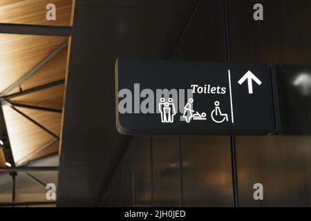 Modern public toilet sign on the wall Stock Photo