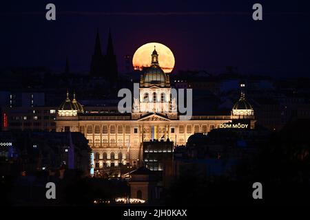 Prague, Czech Republic. 13th July, 2022. Supermoon observed on July 13, 2022, in Prague, Czech Republic. In the foreground is the building of the National Museum. Credit: Ondrej Deml/CTK Photo/Alamy Live News Stock Photo