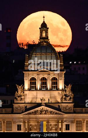 Prague, Czech Republic. 13th July, 2022. Supermoon observed on July 13, 2022, in Prague, Czech Republic. In the foreground is the building of the National Museum. Credit: Ondrej Deml/CTK Photo/Alamy Live News Stock Photo