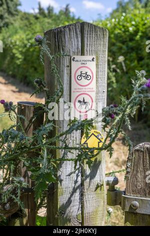 A no cycling and horse riding sign on a rural public footpath gatepost Stock Photo