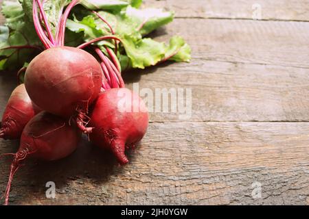 Fresh beetroot with leaves on a wooden background. Healthy food. Top view. Free space for your text Stock Photo