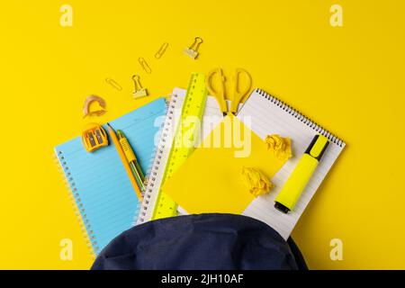 Video of composition with backpack and school items on yellow surface Stock Photo