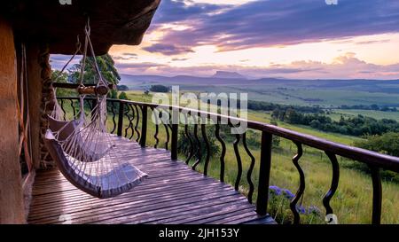 Drakensberg Giant Castle South Africa, Lodge in the mountains during sunset. beautiful lodge in a rock Stock Photo