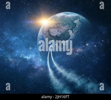 Spaceships, space probes traveling through galaxy, returning planet Earth, sun rising behind - Elements of this image furnished by NASA Stock Photo