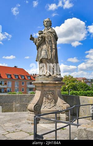 Würzburg, Germany - June 2022: Sculpture of  Archbishop Charles Borromeo at famous old Main bridge called 'Alte Mainbrücke' Stock Photo