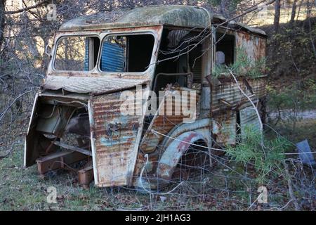 destroyed old rusty abandoned delivery van in the country in france Stock Photo