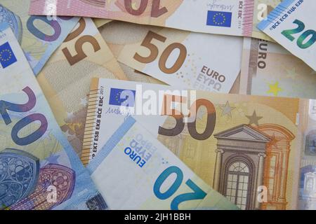 Close-up of a pile of euro bills with values of €20 and €50 seen from above, economic backgrounds Stock Photo