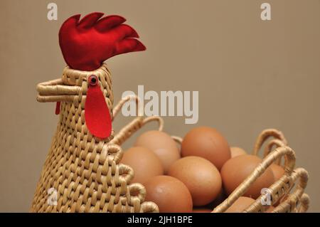 Chicken and egg, Eggs in a chicken shape basket Stock Photo
