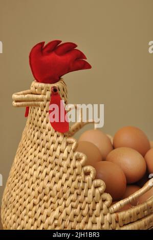 Chicken and egg, Eggs in a chicken shape basket Stock Photo