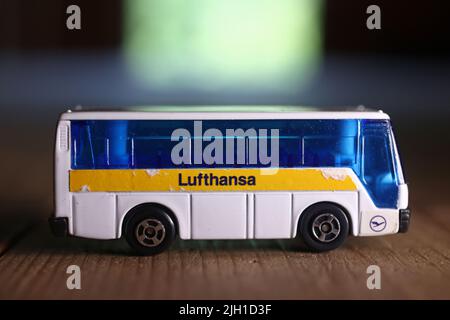 Toys in a box in an attic of a house. Here are small toy cars, a Lufthansa bus. Stock Photo