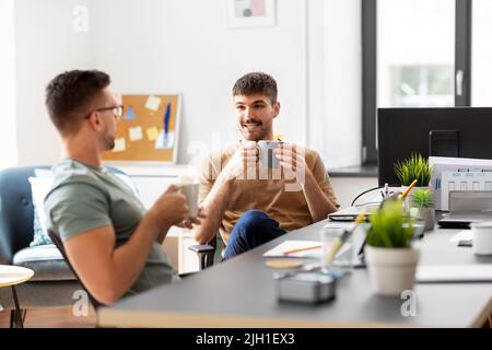 men or startuppers drinking coffee at office Stock Photo