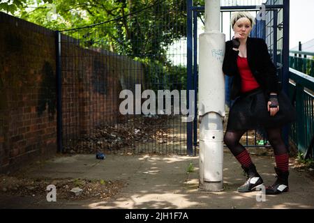 Urban Gothic. A confident portrait of an alternative lifestyle teenage female model with facial piercings. From a series with the same model. Stock Photo