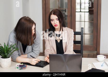 Female designers discussing corporate style Stock Photo