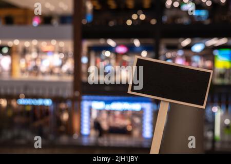 Blank Black billboard against shop Empty mockup template Blackboard label at shopping mall store. Shopping center. Department store. Shopping online Stock Photo