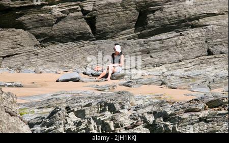A pretty lady writing on the beach Stock Photo
