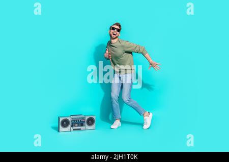 Full length photo of 80s motion disco dancer boom box fun wear pullover isolated blue color background Stock Photo
