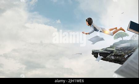 World of books concept with flying boy Stock Photo