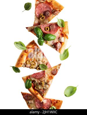 Flying food. Pizza slices with cheese, sausages, salami, olives and basil in levitation close up isolated on a transparent background. Vertical orient Stock Photo