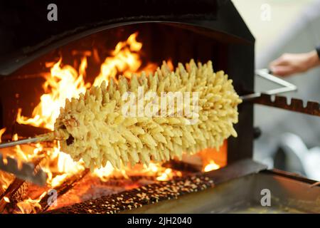 Traditional Lithuanian tree cake called sakotis baked at Kaziukas, an annual Easter fair in Vilnius, Lithuania Stock Photo