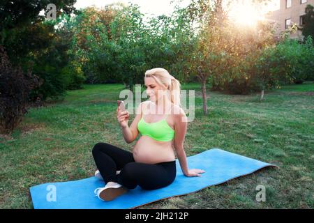 Smiling woman chatting on smartphone outdoor Stock Photo