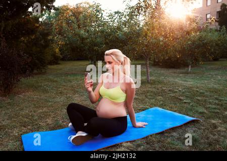Smiling woman chatting on smartphone outdoor Stock Photo
