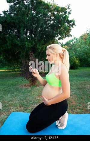 Pregnant woman call doctor close-up Stock Photo