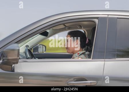 Side shot of woman driving a car Stock Photo
