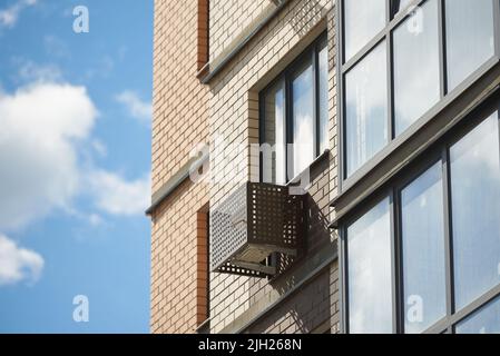 Facade of apartment building with decorative air conditioner covers. Stock Photo