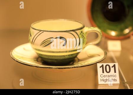 An earthenware cup and saucer by Michael Cardew on display at the Potteries Museum and Art Gallery, Hanley, Stoke-on-Trent, Staffs, England, UK Stock Photo