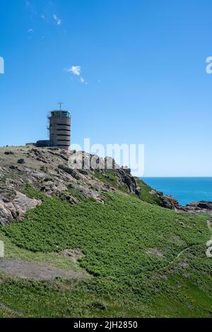 La Corbiere WW2 watchtower on the headland of St Brelade in the sout-west of the British Crown Dependency of Jersey, Channel Islands, British Isles. Stock Photo