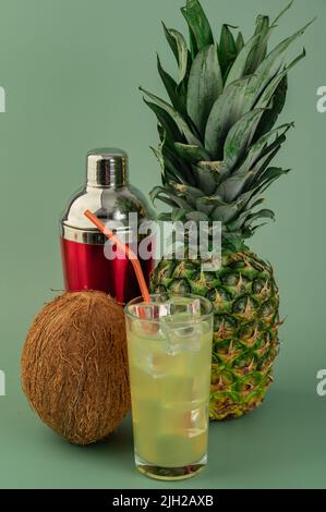 Pina Colada refreshing summer tasty refreshing alcoholic cocktail beverage on Green background Stock Photo