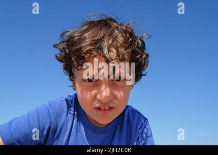 Portrait of little cute arabian preschool bully boy with hazel eyes and exciting emotion face looking gaze with curiosity and interest. Stock Photo