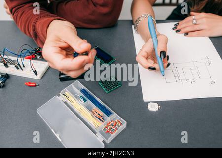 Drawing modern electronic circuit on paper Stock Photo