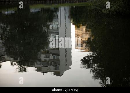 Reflection in puddle. House is reflected in water. Stock Photo
