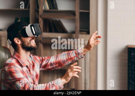 Happy bearded man using vr glasses Stock Photo