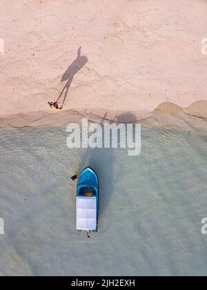 Aerial view of a man walking with his surfboard on the beach Stock ...