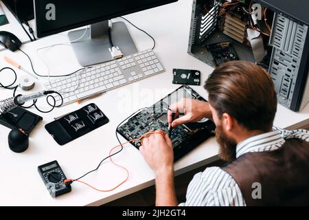 Engineer testing computer circuit with multitester Stock Photo