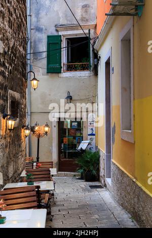 SIBENIK, CROATIA - SEPTEMBER 9, 2016: This is an empty cafe in a small alley of the old medieval city on an autumn evening. Stock Photo